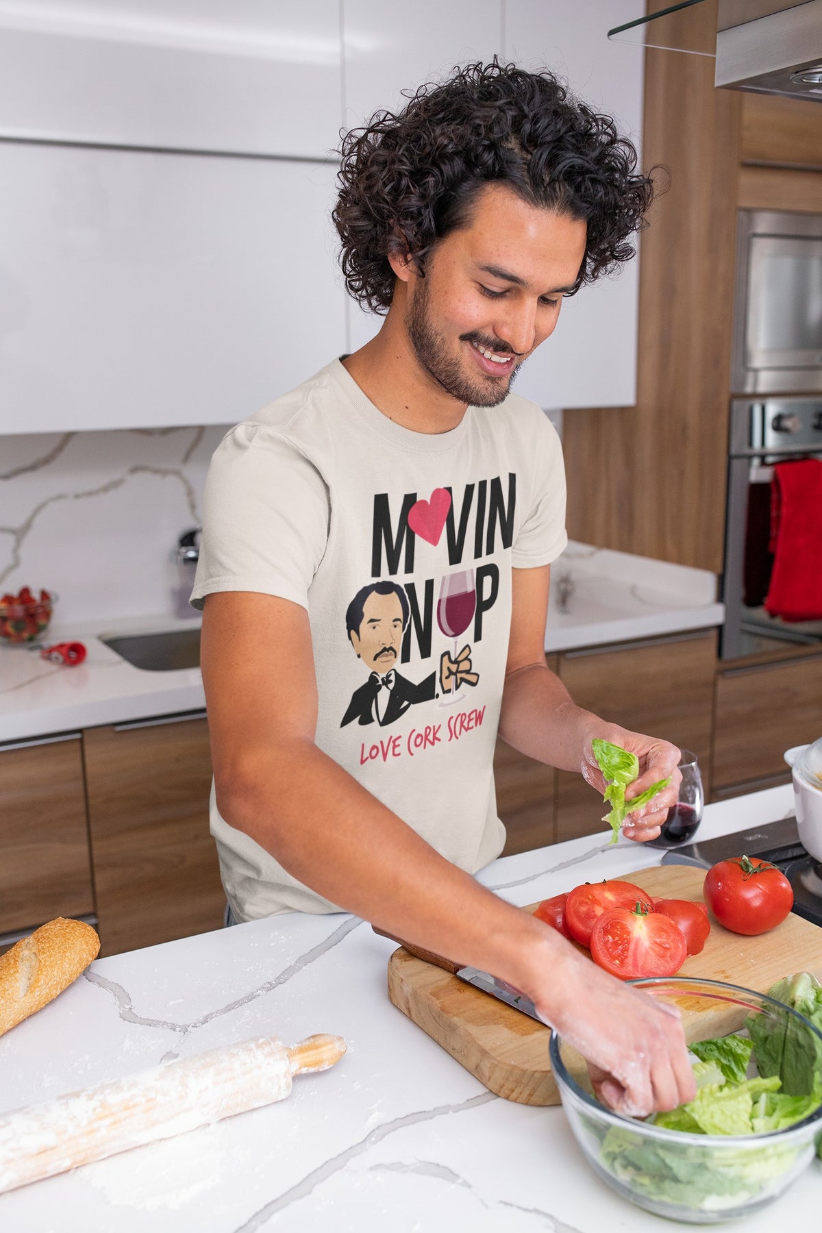 Man cooking in the Movin' On Up tee by Love Cork Screw